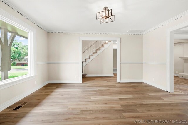 6722 S 72nd E Ave, Tulsa, OK 74133 - unfurnished dining area with a chandelier, stairway, baseboards, light wood-style floors, and crown molding