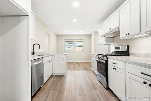 6722 S 72nd E Ave, Tulsa, OK 74133 - kitchen with appliances with stainless steel finishes, a sink, light wood-style floors, white cabinetry, and under cabinet range hood