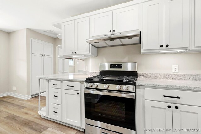 6722 S 72nd E Ave, Tulsa, OK 74133 - kitchen with stainless steel gas range, under cabinet range hood, light wood-style floors, white cabinets, and light stone counters
