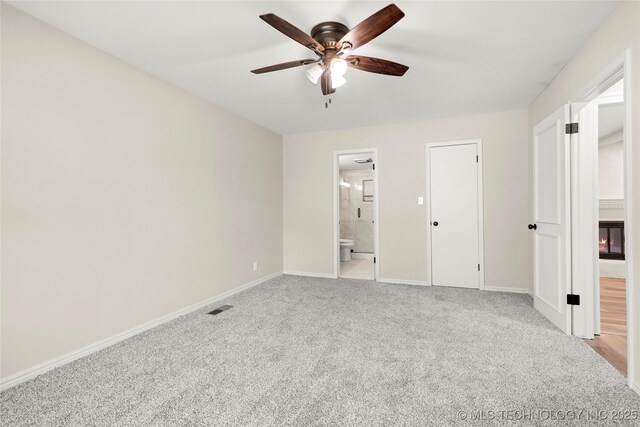 6722 S 72nd E Ave, Tulsa, OK 74133 - unfurnished bedroom featuring light colored carpet, ensuite bath, baseboards, and ceiling fan