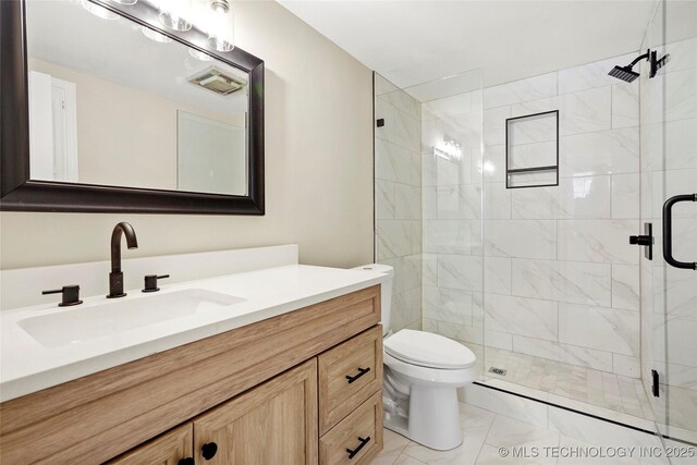 6722 S 72nd E Ave, Tulsa, OK 74133 - bathroom featuring marble look tile flooring, vanity, a stall shower, and toilet