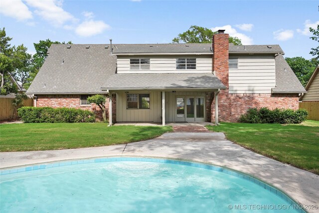 6722 S 72nd E Ave, Tulsa, OK 74133 - back of house with brick siding, french doors, a chimney, a patio area, and a shingled roof