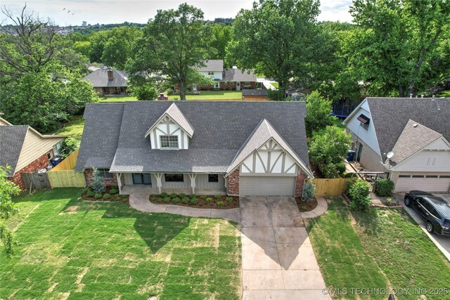 6722 S 72nd E Ave, Tulsa, OK 74133 - view of front of house with an attached garage, driveway, covered porch, and roof with shingles