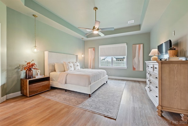 3009 W Van Buren Ct, Broken Arrow, OK 74011 - bedroom with a raised ceiling, light wood-style floors, and a ceiling fan