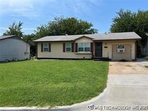 5922 N Garrison Ave, Tulsa, OK 74126 - ranch-style home featuring concrete driveway and a front lawn