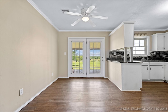 1822 Abner Rd, Overbrook, OK 73453 - kitchen with dark countertops, dark wood-type flooring, a sink, backsplash, and ornamental molding