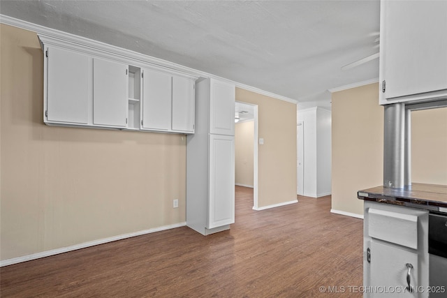 1822 Abner Rd, Overbrook, OK 73453 - kitchen featuring wood finished floors, baseboards, ornamental molding, dark countertops, and white cabinets