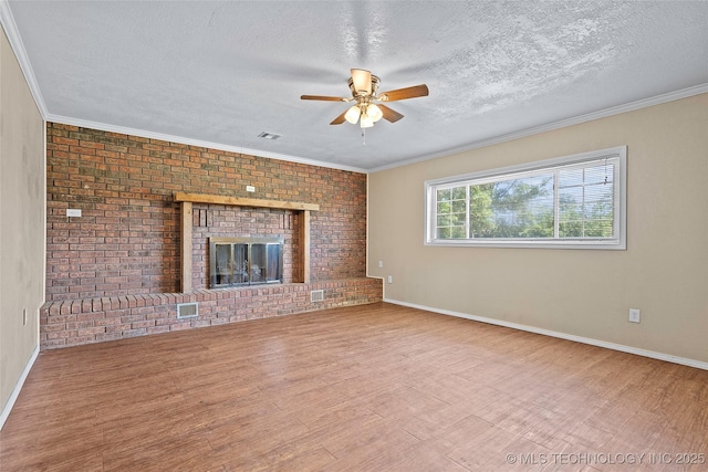 1822 Abner Rd, Overbrook, OK 73453 - unfurnished living room with a ceiling fan, wood finished floors, a textured ceiling, baseboards, and a brick fireplace