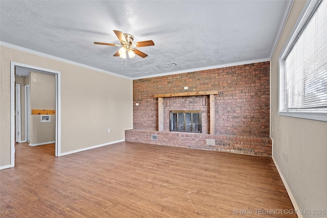 1822 Abner Rd, Overbrook, OK 73453 - unfurnished living room featuring wood finished floors, ceiling fan, a brick fireplace, baseboards, and a textured ceiling