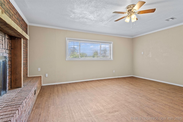1822 Abner Rd, Overbrook, OK 73453 - unfurnished living room featuring a textured ceiling, wood finished floors, ornamental molding, a brick fireplace, and ceiling fan