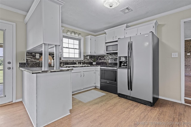 1822 Abner Rd, Overbrook, OK 73453 - kitchen featuring appliances with stainless steel finishes, tasteful backsplash, light wood finished floors, and ornamental molding