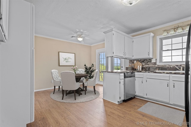 1822 Abner Rd, Overbrook, OK 73453 - kitchen with stainless steel dishwasher, light wood-type flooring, plenty of natural light, ornamental molding, and a textured ceiling