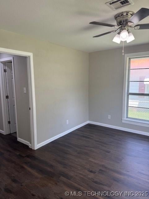 904 W Tishomingo, Madill, OK 73446 - spare room with baseboards, dark wood-style flooring, and a ceiling fan