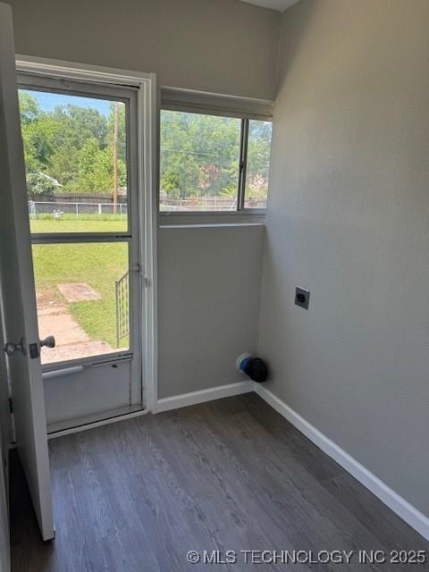 904 W Tishomingo, Madill, OK 73446 - laundry area with hookup for an electric dryer, plenty of natural light, and baseboards