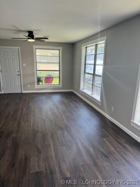 904 W Tishomingo, Madill, OK 73446 - empty room featuring baseboards, dark wood-type flooring, and a ceiling fan