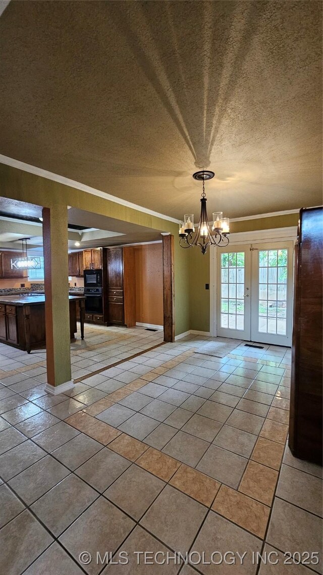 6401 S 86th E Ave, Tulsa, OK 74133 - unfurnished dining area with crown molding, a textured ceiling, light tile patterned flooring, and a chandelier