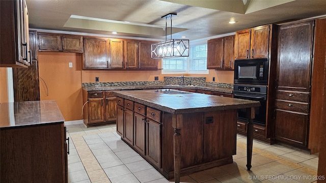 6401 S 86th E Ave, Tulsa, OK 74133 - kitchen featuring black appliances, dark countertops, light tile patterned floors, a tray ceiling, and a center island