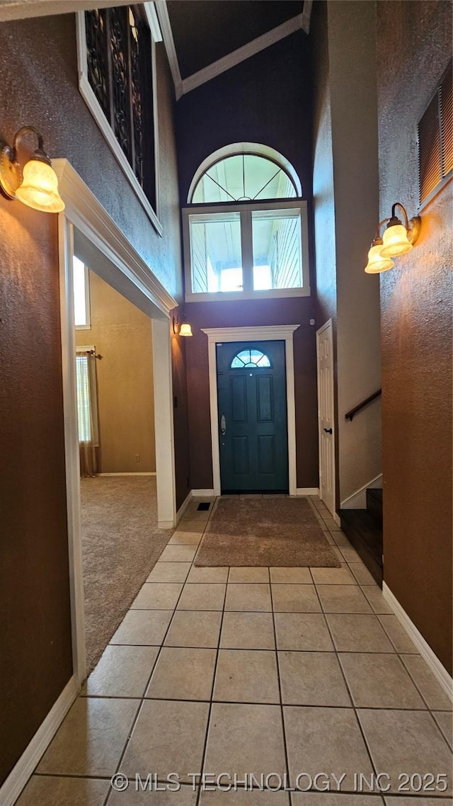 6401 S 86th E Ave, Tulsa, OK 74133 - entrance foyer featuring a high ceiling, light tile patterned flooring, ornamental molding, and stairs