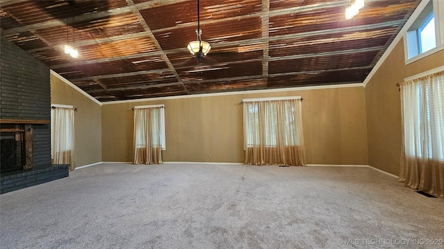 6401 S 86th E Ave, Tulsa, OK 74133 - unfurnished living room with carpet floors, a brick fireplace, lofted ceiling, crown molding, and wood ceiling