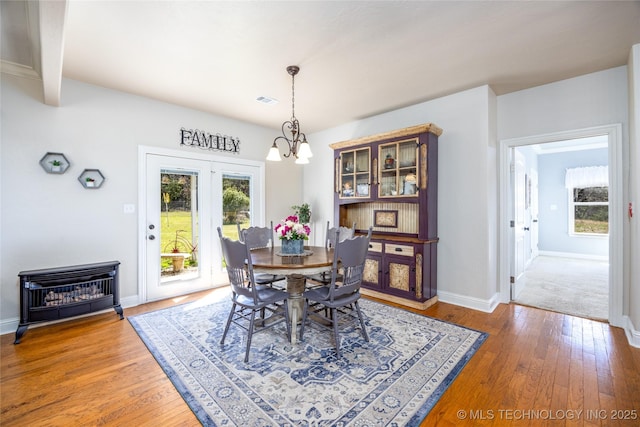 3127 Pleasant Hill Rd, Caddo, OK 74729 - dining area featuring a chandelier, hardwood / wood-style floors, and baseboards