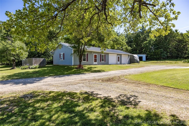 3127 Pleasant Hill Rd, Caddo, OK 74729 - view of front of house with dirt driveway, a front yard, a detached garage, and metal roof