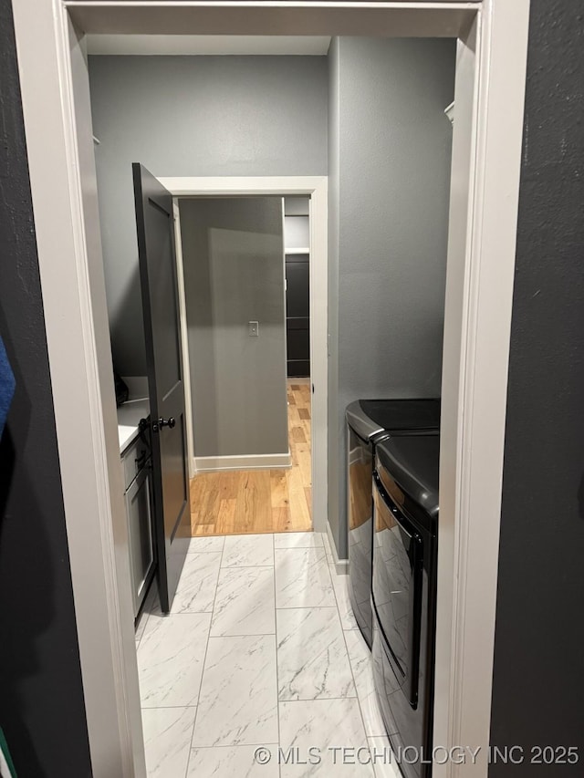 1508 N 72nd St, Broken Arrow, OK 74014 - laundry area with washing machine and dryer, light marble finish floors, and baseboards