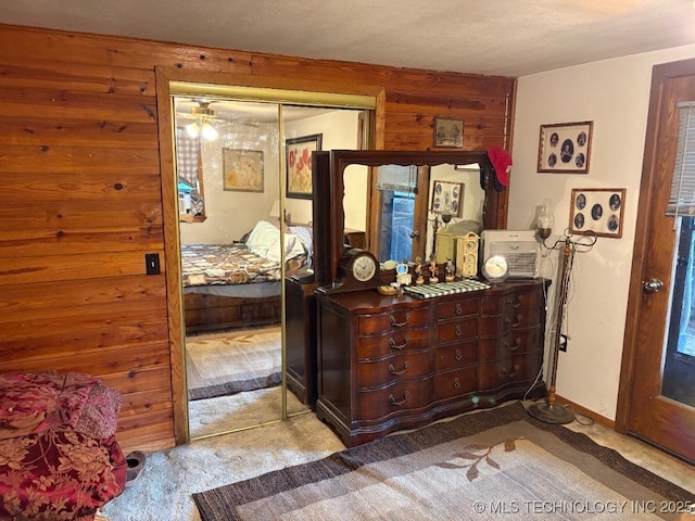 472422 E 754th Rd, Westville, OK 74965 - bedroom with carpet floors, wooden walls, and a closet
