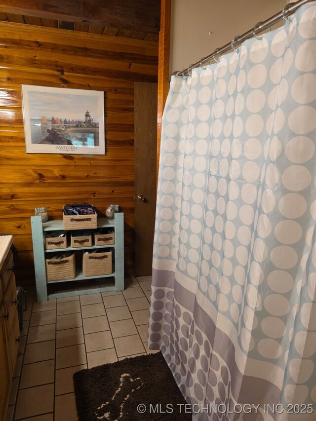472422 E 754th Rd, Westville, OK 74965 - full bath featuring tile patterned flooring, vanity, wood walls, and curtained shower