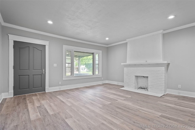 328 I St SW, Ardmore, OK 73401 - unfurnished living room featuring ornamental molding, wood finished floors, recessed lighting, and a brick fireplace
