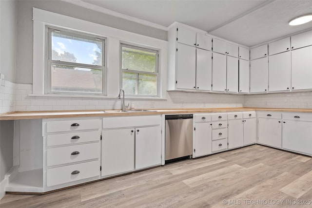 328 I St SW, Ardmore, OK 73401 - kitchen with stainless steel dishwasher, light countertops, light wood finished floors, white cabinets, and ornamental molding