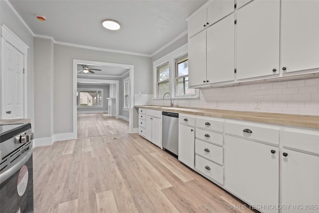 328 I St SW, Ardmore, OK 73401 - kitchen featuring appliances with stainless steel finishes, light countertops, decorative backsplash, light wood-style floors, and crown molding