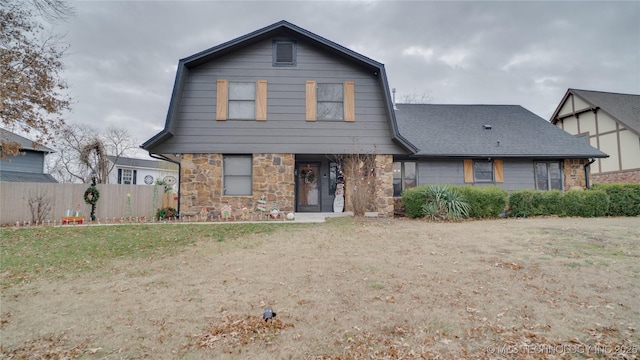 8722 E 74th Pl, Tulsa, OK 74133 - dutch colonial with a gambrel roof, stone siding, and a shingled roof