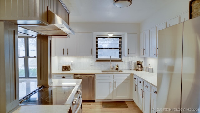 8722 E 74th Pl, Tulsa, OK 74133 - kitchen featuring stainless steel appliances, a sink, healthy amount of natural light, and decorative backsplash