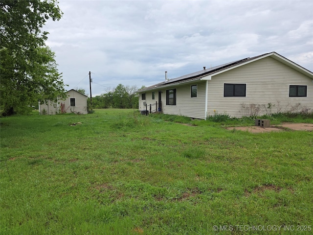 14202 E 492nd Rd, Claremore, OK 74019 - back of property featuring solar panels and a yard
