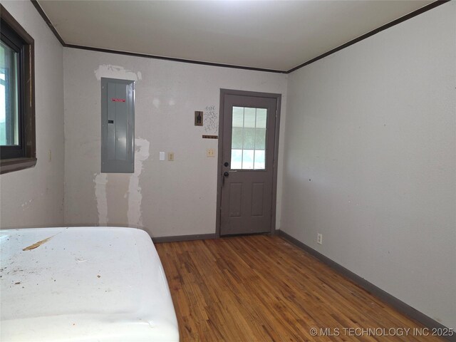 14202 E 492nd Rd, Claremore, OK 74019 - bedroom featuring electric panel, wood finished floors, and ornamental molding