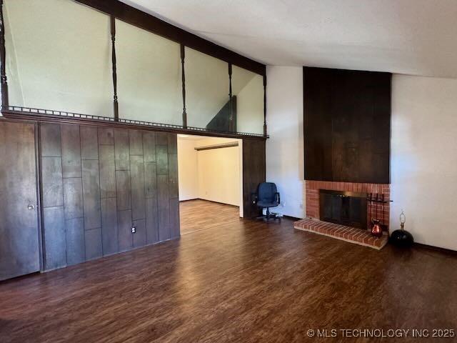 1822 N Xenophon Ave, Tulsa, OK 74127 - unfurnished living room with a brick fireplace, beamed ceiling, wood finished floors, and high vaulted ceiling
