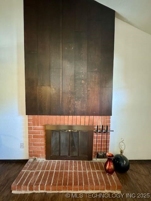 1822 N Xenophon Ave, Tulsa, OK 74127 - detailed view of a brick fireplace and wood finished floors