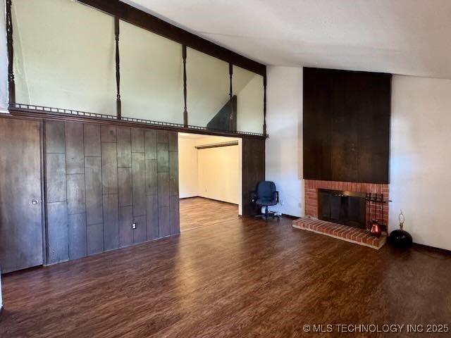1822 N Xenophon Ave, Tulsa, OK 74127 - unfurnished living room with a brick fireplace, wood finished floors, beam ceiling, and high vaulted ceiling