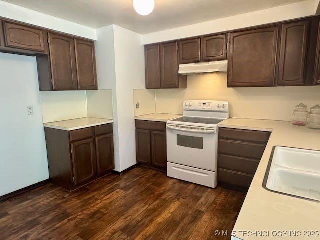 1822 N Xenophon Ave, Tulsa, OK 74127 - kitchen with white range with electric stovetop, under cabinet range hood, dark brown cabinets, and light countertops