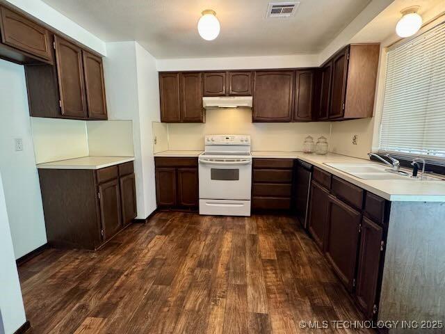 1822 N Xenophon Ave, Tulsa, OK 74127 - kitchen with electric stove, under cabinet range hood, dark wood-style flooring, and dark brown cabinetry