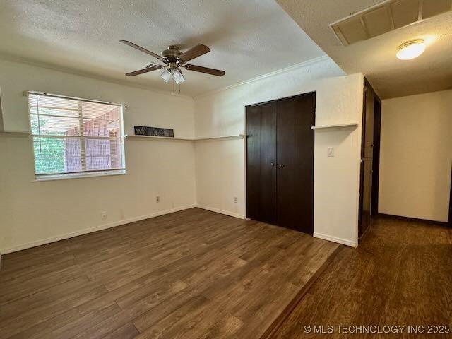 1822 N Xenophon Ave, Tulsa, OK 74127 - unfurnished bedroom with wood finished floors, a closet, and a textured ceiling
