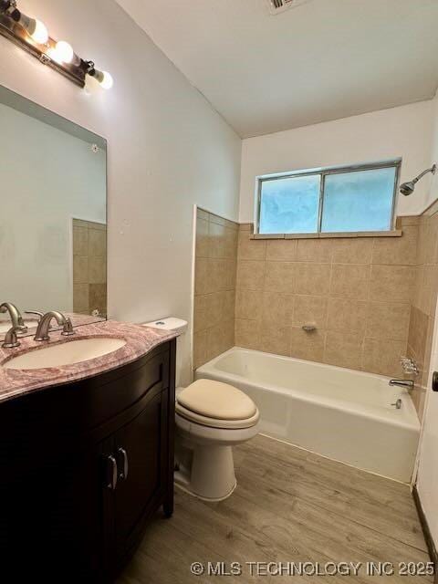 1822 N Xenophon Ave, Tulsa, OK 74127 - bathroom featuring vanity, wood finished floors, washtub / shower combination, and lofted ceiling