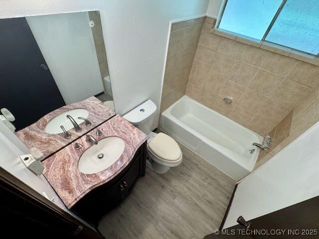 1822 N Xenophon Ave, Tulsa, OK 74127 - full bathroom with a bathtub, vanity, and wood finished floors