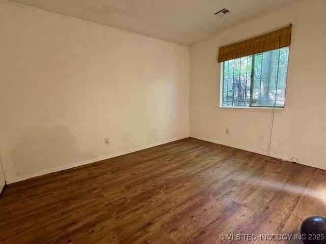 1822 N Xenophon Ave, Tulsa, OK 74127 - empty room featuring dark wood-type flooring and baseboards