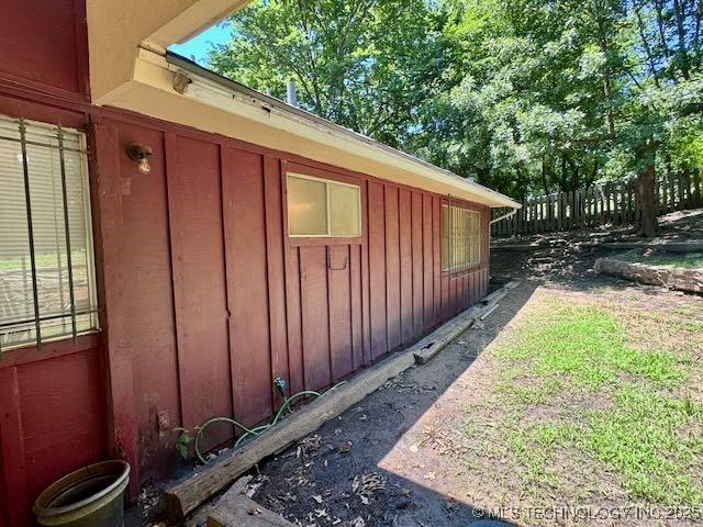 1822 N Xenophon Ave, Tulsa, OK 74127 - view of side of home with board and batten siding