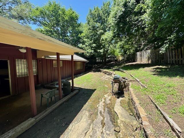 1822 N Xenophon Ave, Tulsa, OK 74127 - fenced yard featuring a patio