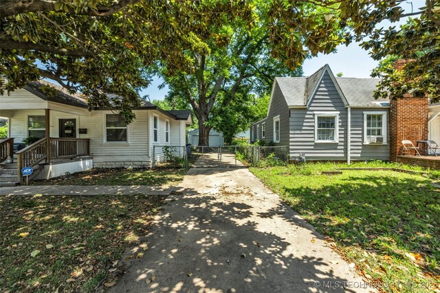 149 N Columbia Pl, Tulsa, OK 74110 - view of front of property with driveway and a gate