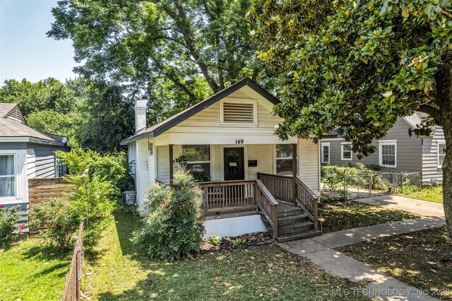 149 N Columbia Pl, Tulsa, OK 74110 - view of front of property with a porch and a chimney