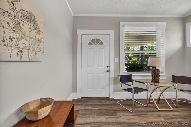 149 N Columbia Pl, Tulsa, OK 74110 - entryway featuring wood finished floors, crown molding, and a textured ceiling