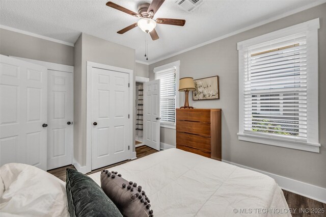 149 N Columbia Pl, Tulsa, OK 74110 - bedroom featuring dark wood-type flooring, ornamental molding, a ceiling fan, and a closet